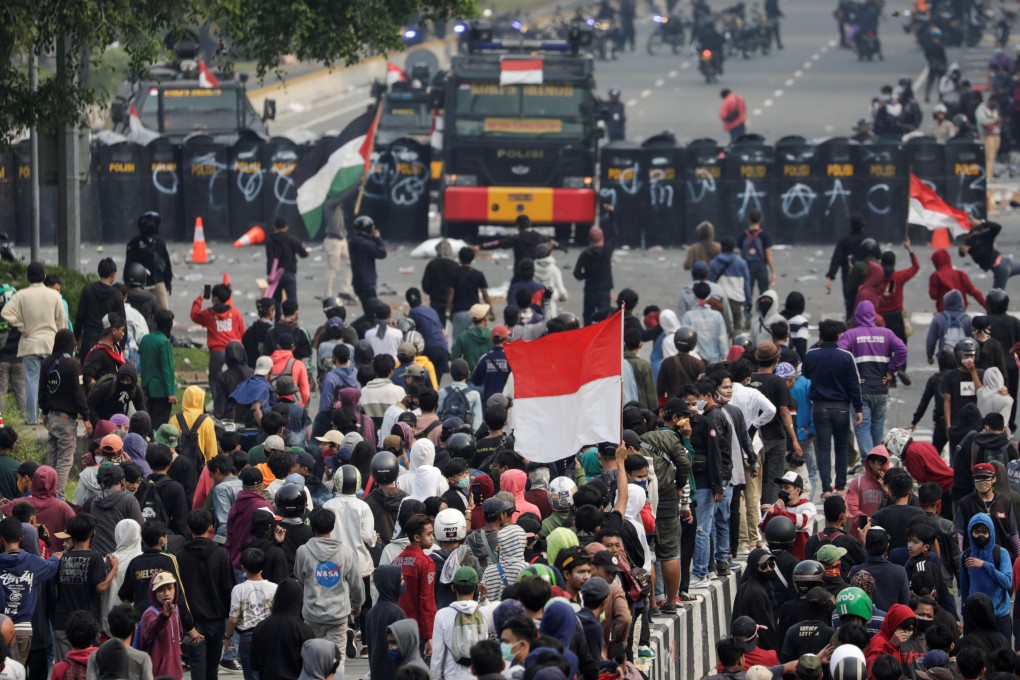 Demonstrators gather in front of police in Jakarta in ongoing protests against Indonesia’s new jobs creation law. Photo: Reuters