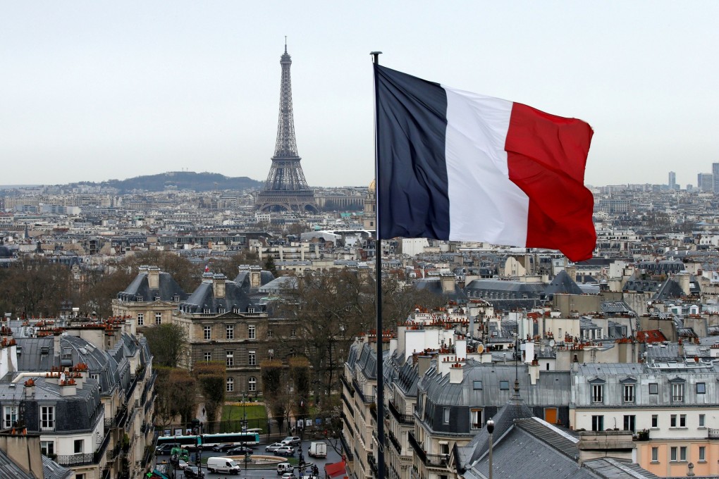 The French flag flies in Paris, with the Eiffel Tower in the background. France’s government is facing criticism at home over its coronavirus strategy. Photo: Reuters