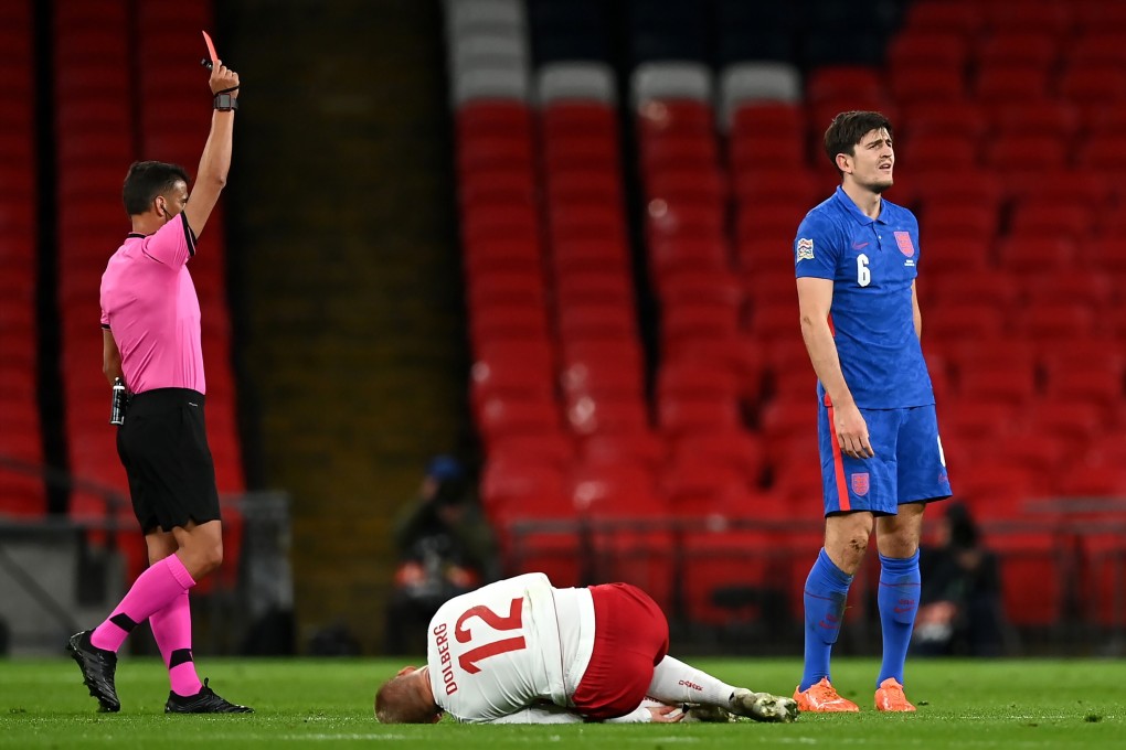 England’s Harry Maguire (R) is shown a red card in the loss against Denmark. Photo: DPA