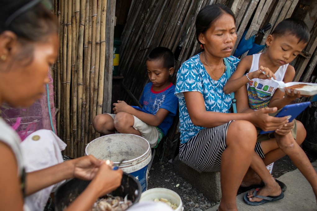A family is seen in a shanty home in Tondo, Manila. The effects of the Covid-19 pandemic are especially severe in emerging parts of Southeast Asia. Photo: Reuters