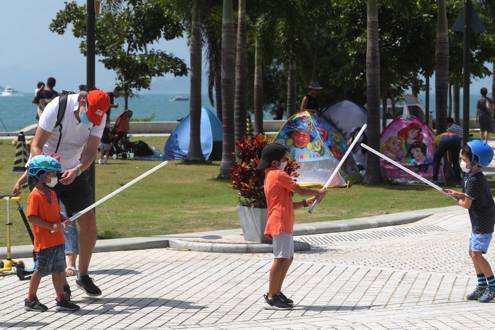 Children play at sword fighting at the West Kowloon Promenade on October 3, during the long National Day and Mid-Autumn Festival weekend. For Hong Kong pre-teens in a recent survey, two of the three lowest scores were for use of leisure time and being listened to by adults. Photo: Edmond So