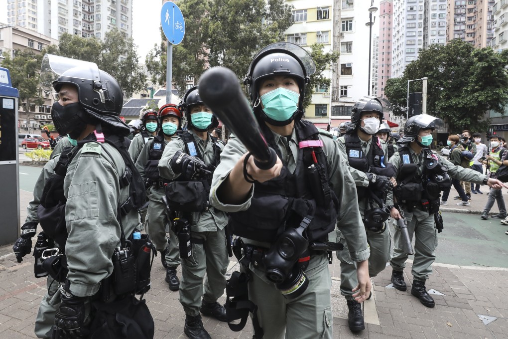 Riot police disperse protesters and media in the Tai Po area of Hong Kong in March. Photo: Dickson Lee