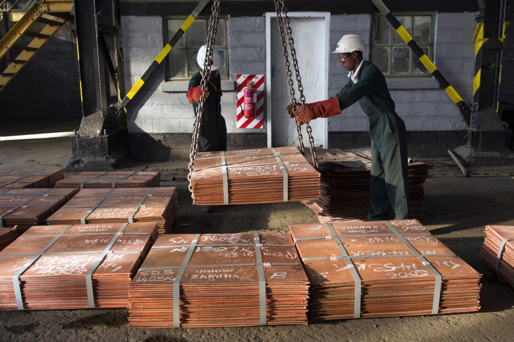 Workers move batches of copper sheets in Mufulira, Zambia. Photo: Getty Images