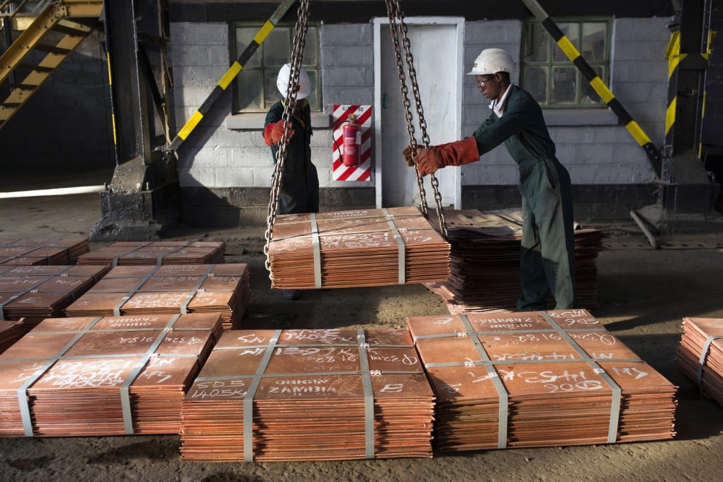 Workers move batches of copper sheets in Mufulira, Zambia. Photo: Getty Images