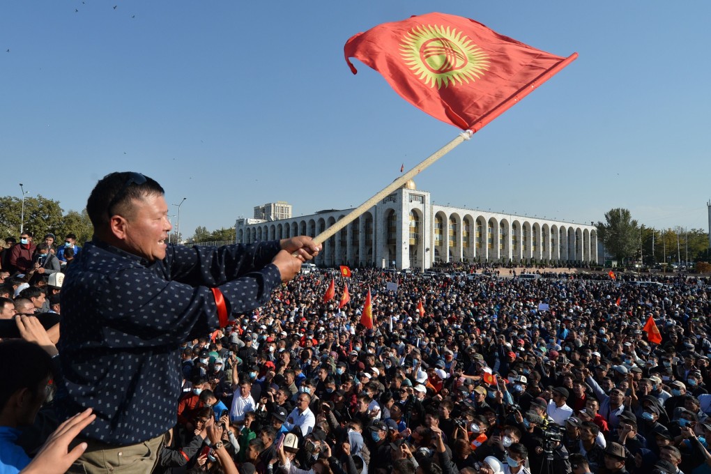 A protester waves a Kyrgyz flag during a rally against the results of a parliamentary vote in Bishkek, Kyrgyzstan, on October 5. Photo: AP