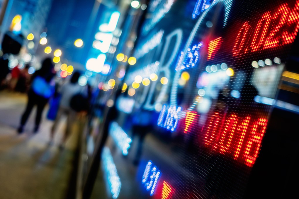 Stock prices are reflected on the screen outside a brokerage in Shanghai, China. Photo: Handout