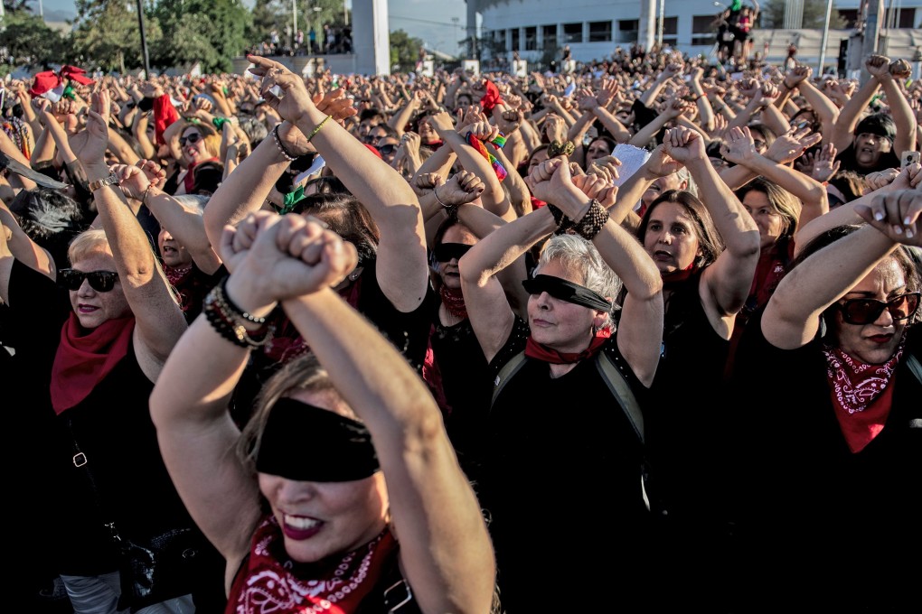 Thousands of women’s rights activists take part in a choreographed performance of the feminist song, “The rapist is you”, in Santiago, Chile on December 04, 2019. Photo: AFP via Getty Images