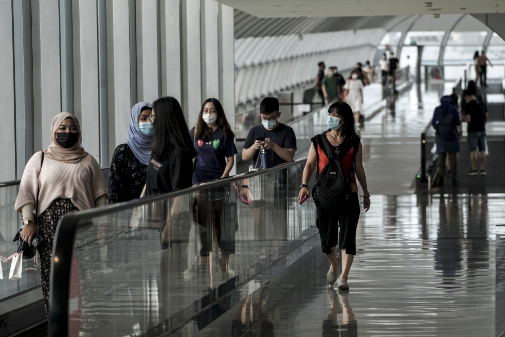 Visitors walk through Singapore’s Changi Airport earlier this month. Interest in travel between Hong Kong and the city state is soaring. Photo: AFP