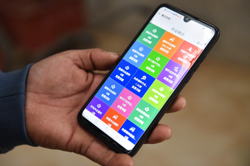 A farmer in Taizhao village in Shanxi province uses his phone to access information made available by technology such as GPS and unmanned aerial vehicles. Asian economies’ embrace of leading growth industries such as information technology has helped an economic recovery. Photo: Xinhua