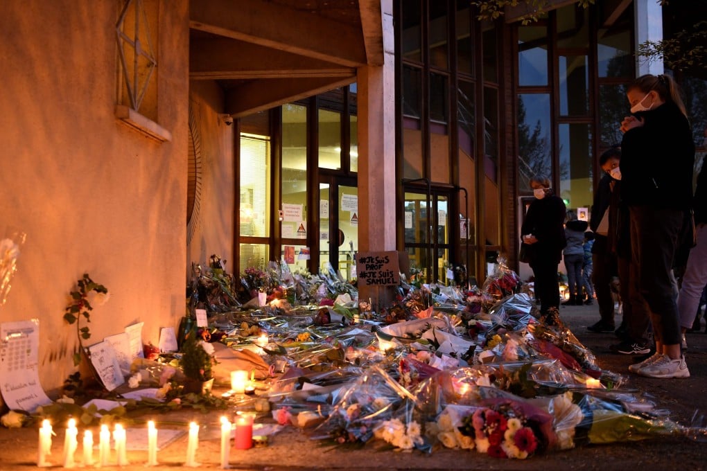 Flowers and candles are laid at the entrance of a school in Conflans-Sainte-Honorine, near Paris, after a teacher was decapitated. Photo: AFP