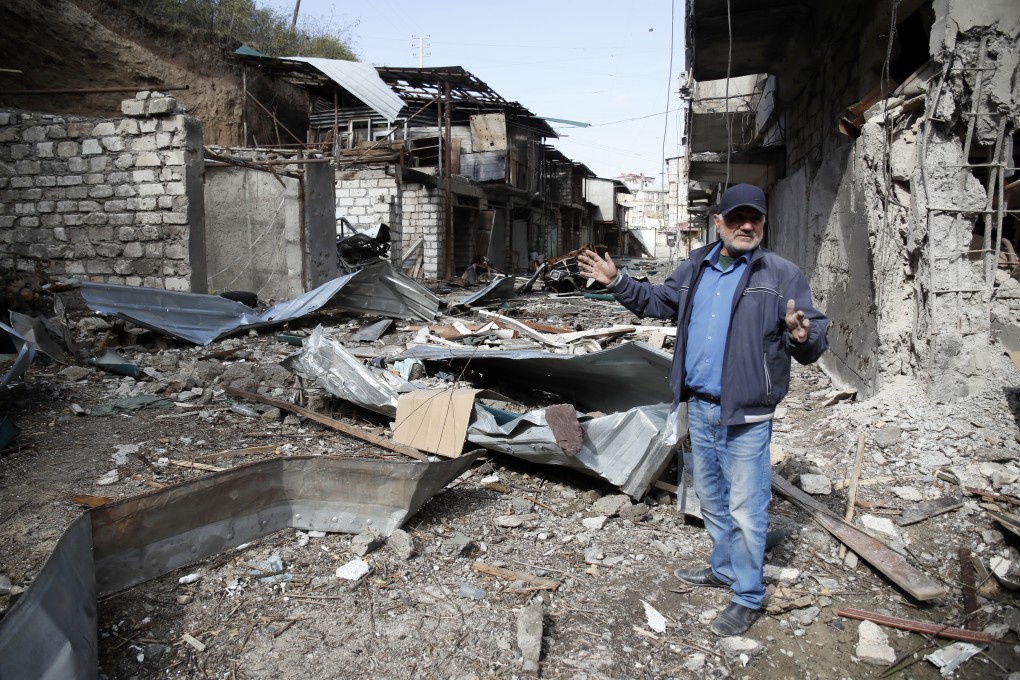 A man in the yard of his apartment building, destroyed by shelling by Azerbaijan’s artillery, in Stepanakert, in Nagorno-Karabakh, on October 10. Photo: AP