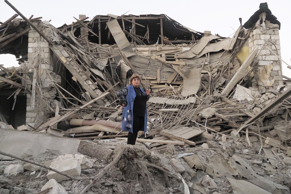 A woman stands near her destroyed house in Stepanakert, Nagorno-Karabakh. Photo: AP