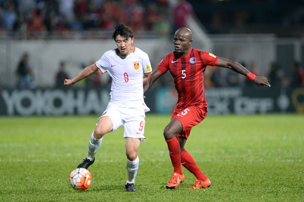 China’s Yang Xu is challenged by Hong Kong’s Jean Jacques Kilama during a Fifa World Cup qualifier in 2015. Photo: AFP