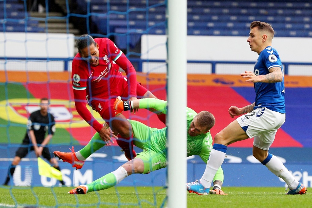 Liverpool’s Virgil van Dijk requires surgery on a damaged knee after a challenge from Everton’s Jordan Pickford. Photo: Reuters