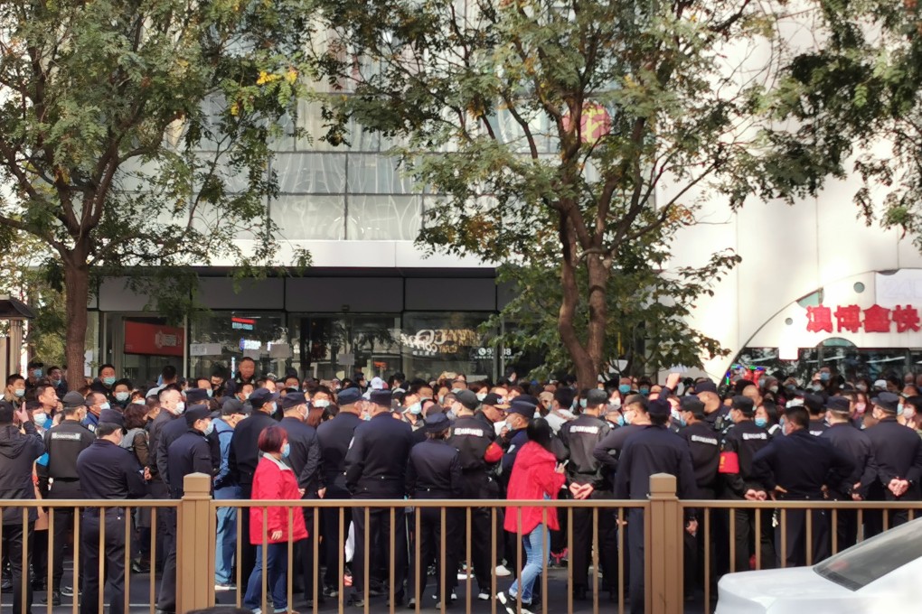 Some 200 people gathered outside the office of Youwin Education in Beijing demanding refunds after the company collapsed. Photo: Frank Tang