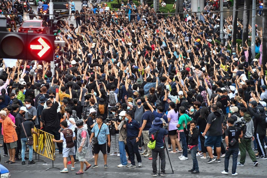 Pro-democracy protesters give the three-finger salute at Wongwian Yai during an anti-government rally in Bangkok on Saturday. Photo: AFP
