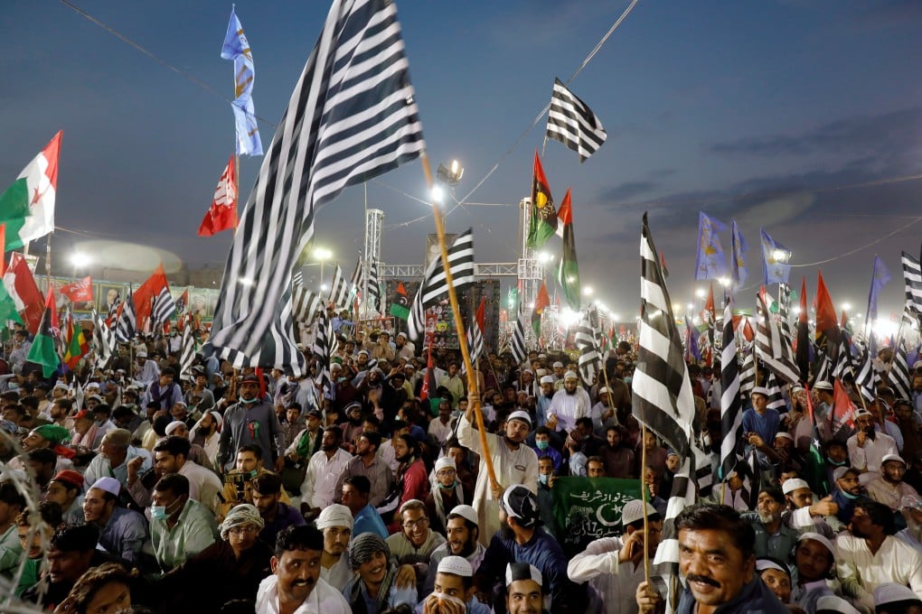 Supporters of the Pakistan Democratic Movement alliance wave flags as they listen to their leaders during an anti-government protest in Karachi on October 18. Photo: Reuters