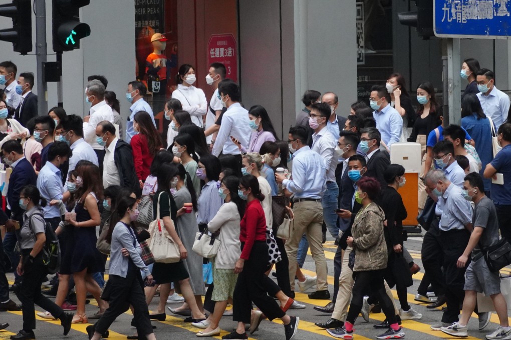 Mask-wearing people cross a road in Central, Hong Kong. Photo: Sam Tsang