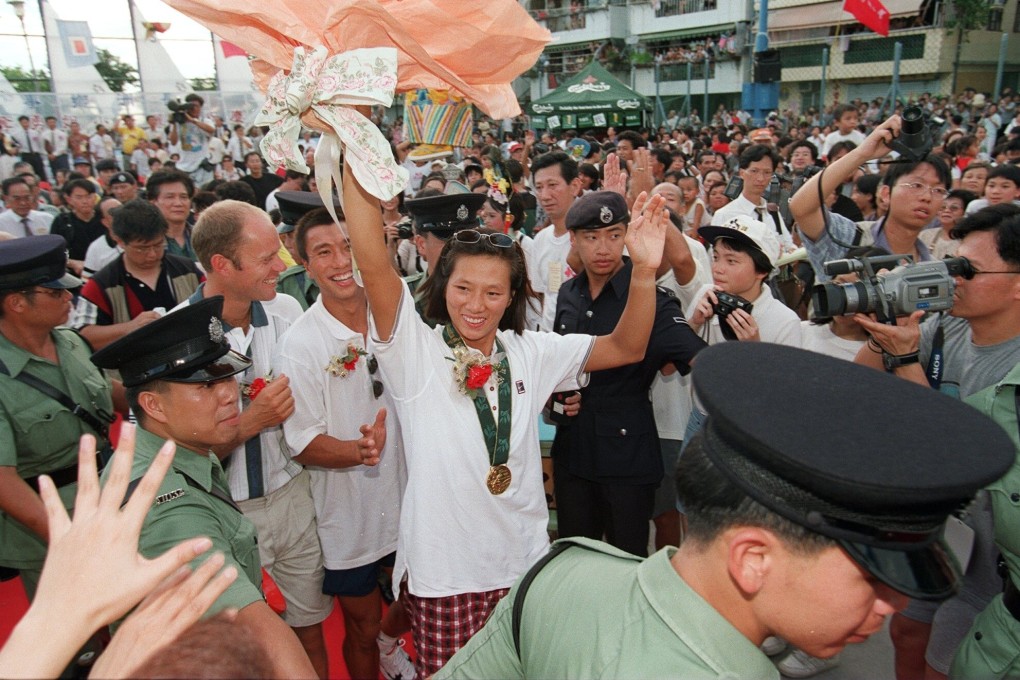 Lee Lai-shan waves to Cheung Chau residents during a celebration for her gold medal win at the Atlanta 1996 Olympic Games. She hopes Hong Kong can increase its tally of Olympic medals at next year’s summer games in Tokyo. Photo: SCMP