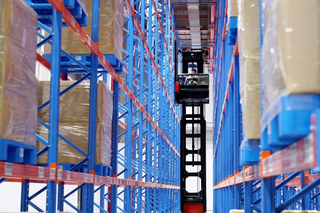 A member of staff works between storage shelves at a logistics centre in Shanghai on June 5. The trade war and Covid-19 have merely accelerated the long-term trend of supply chain reconfiguration. Photo: Xinhua