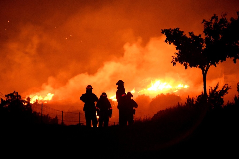 Los Angeles County firefighters keep watch on the Bobcat Fire as it burns through the night in Juniper Hills, California, on September 19. Spatial finance can improve the quality of predictions about the impact of climate change, allowing the financial sector to conduct a more accurate assessment of environmental risks. Photo: Reuters