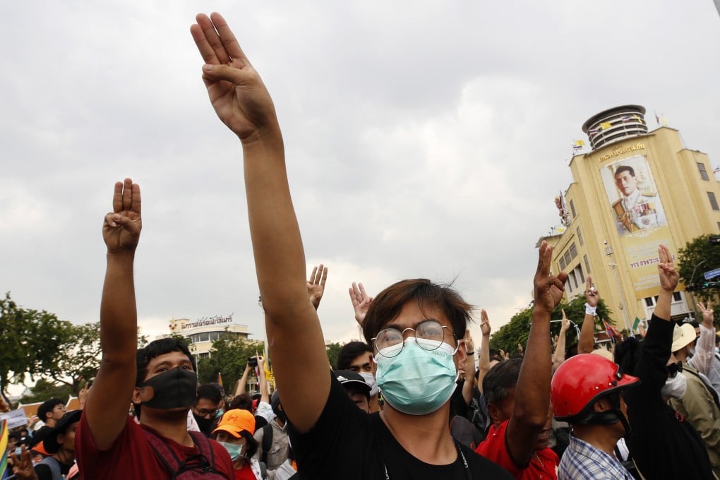 Thai anti-government protesters next to a portrait of King Maha Vajiralongkorn in Bangkok. Photo: EPA