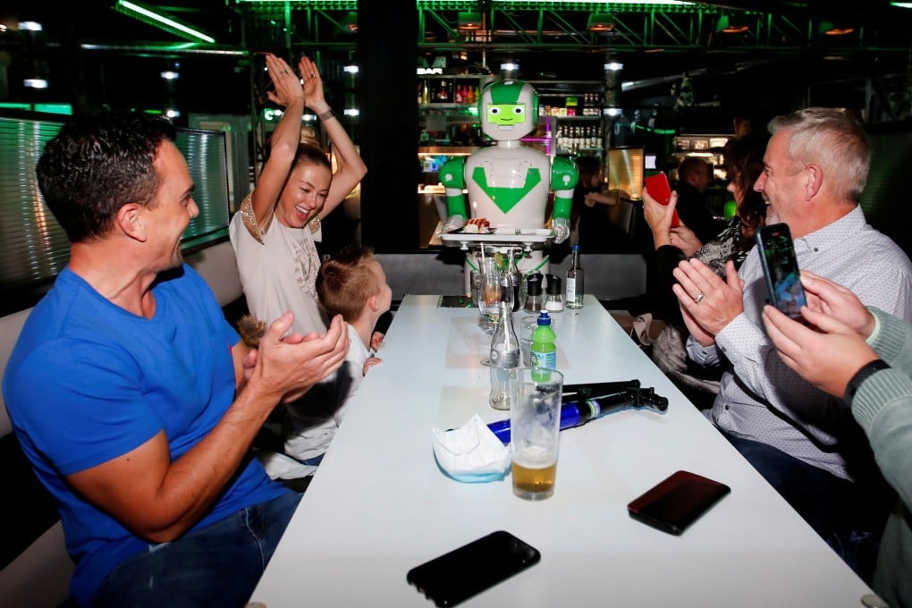 A robot delivers a birthday cake at Robotazia restaurant as the coronavirus outbreak continues in Milton Keynes, Britain, October 2, 2020. Photo: Reuters