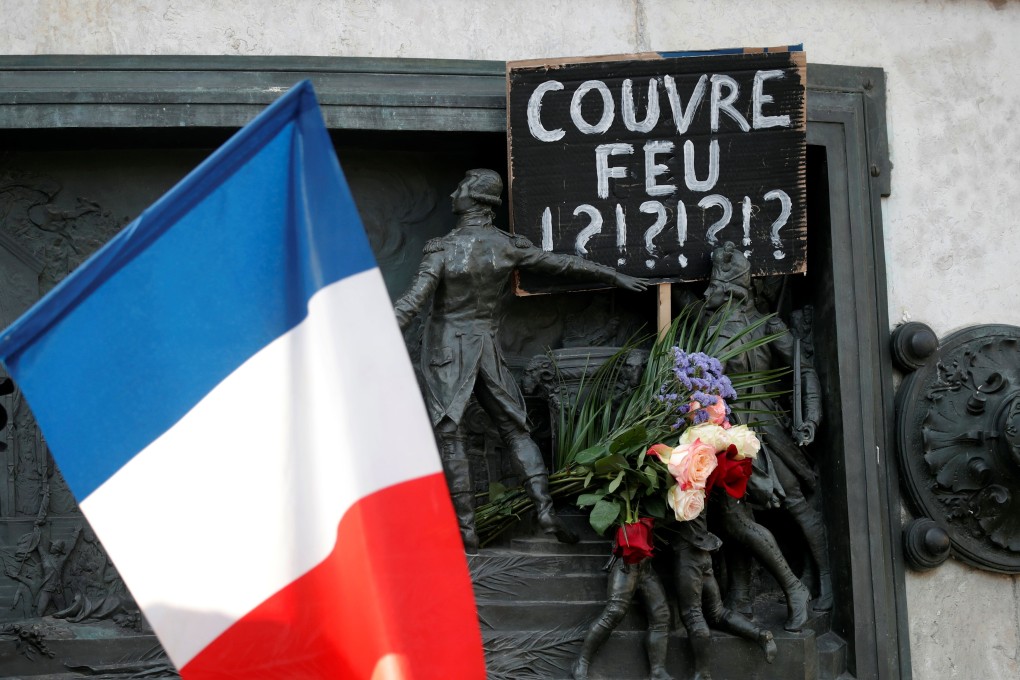 A placard placed on the Republique statue in Paris on October 18 questions the French government’s controversial imposition of an overnight curfew after a rise in Covid-19 infections. Photo: Reuters