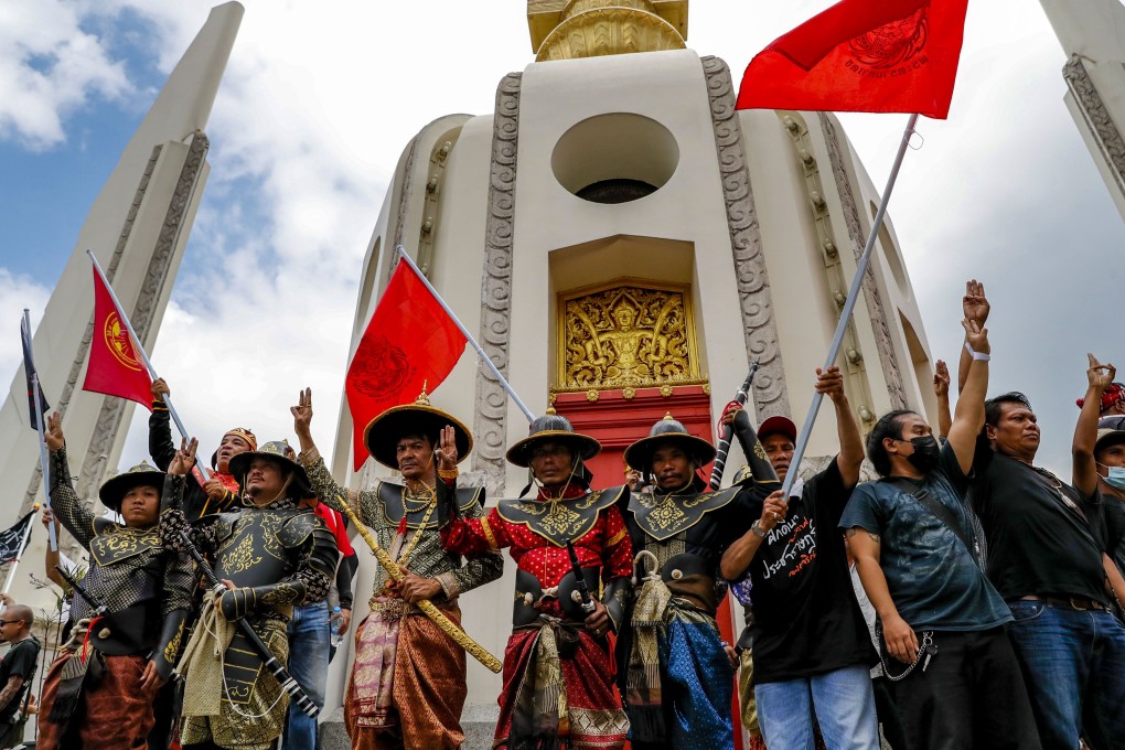 Protesters, some in ancient Thai warrior costumes, flash the three-fingered salute after occupying the Democracy Monument in Bangkok, Thailand, on October 14. The Thai demonstrations have been attracting large crowds, but many video clips and photos being shared on social media are unrelated to the protests. Photo: AP