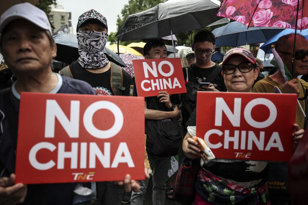 Protesters in Taiwan carry banners and shout slogans as they march in the street in September last year to show their support for the anti-government movement in Hong Kong. Photo: EPA-EFE