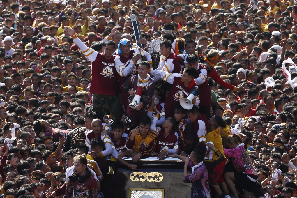 Catholic devotees flock to the Black Nazarene on a procession through Manila to mark its feast day in January. Photo: EPA