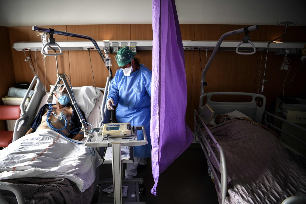 A nurse tends to a patient infected with Covid-19 in the infectious diseases unit of the Gonesse hospital north of Paris. Photo: AFP