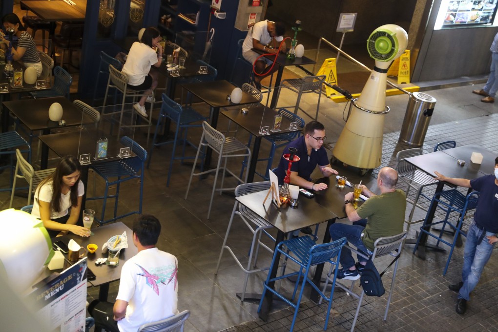 Patrons enjoy a drink at a bar in Tsim Sha Tsui on October 5. Hong Kong bars had been closed for three of the last six months to comply with the government’s pandemic containment measures, before they reopened on September 18. Photo: Edmond So