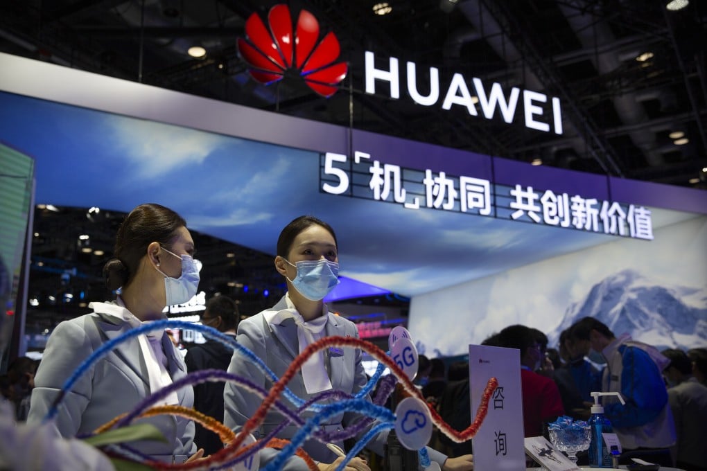 Staff members wearing face masks to protect against the coronavirus stand at a booth from Chinese technology firm Huawei at the PT Expo in Beijing, Wednesday, Oct. 14, 2020. Photo: AP