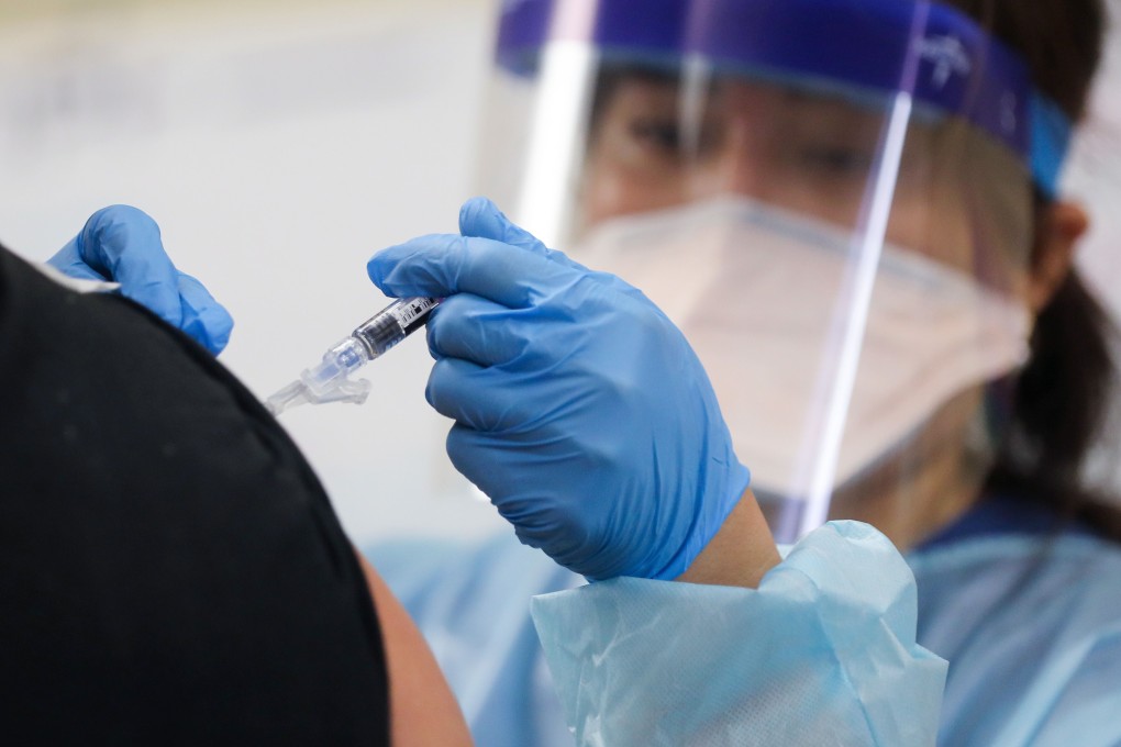 A nurse gives a flu vaccination shot to a man earlier this month. Photo: AFP