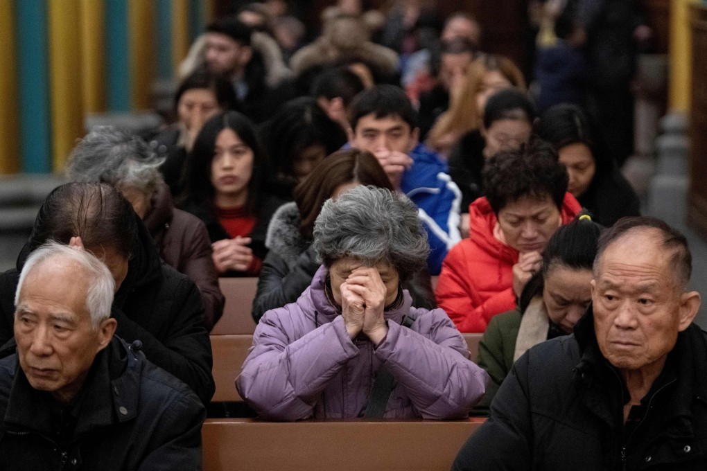 Worshippers are seen at a Christmas Eve mass at the Xishiku Cathedral in Beijing in 2019. Photo: AFP
