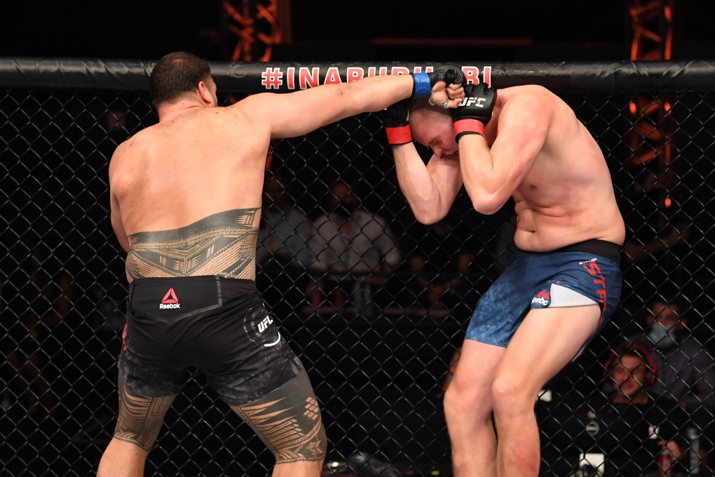 Tai Tuivasa punches Stefan Struve in their heavyweight bout during UFC 254. Photos: Josh Hedges/Zuffa LLC via Getty Images