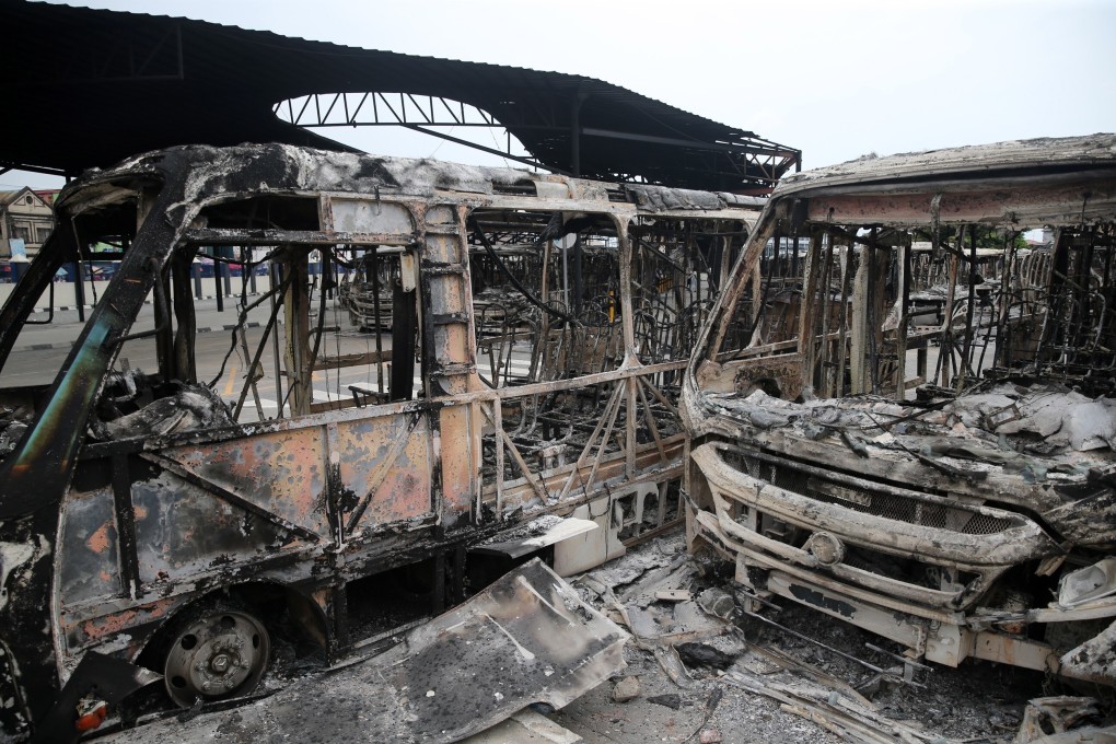 Burnt vehicles at a bus terminal in Lagos, Nigeria. Photo: EPA
