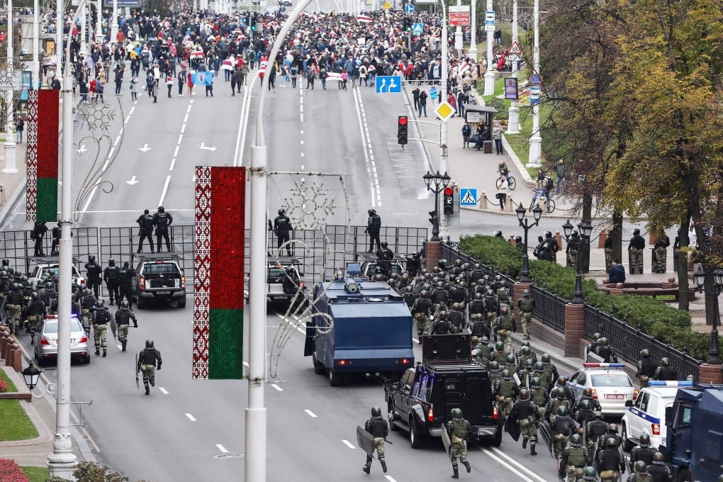 Law enforcement officers block a road as opposition supporters gather in Minsk on Sunday, the final day of an ultimatum set by the opposition for Belarus’ embattled strongman leader to resign. Photo: AFP