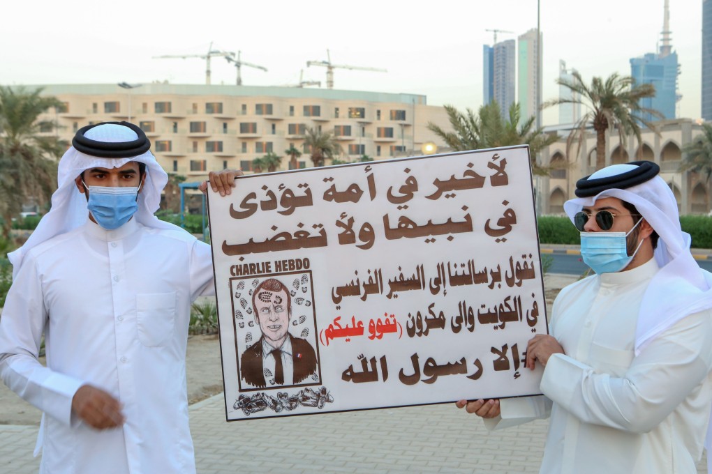 Kuwaitis hold placards expressing anger at French President Emmanuel Macron at a rally in Kuwait City, on Saturday. Photo: AFP