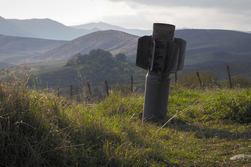 A tail of a multiple rocket 'Smerch' sticks out of the ground near the town of Martuni, the separatist region of Nagorno-Karabakh. Photo: AP