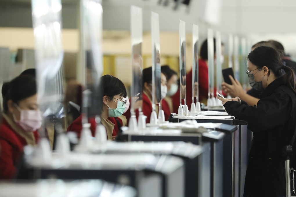 Cathay Pacific staff check-in passengers at Hong Kong International Airport. Photo: K. Y. Cheng