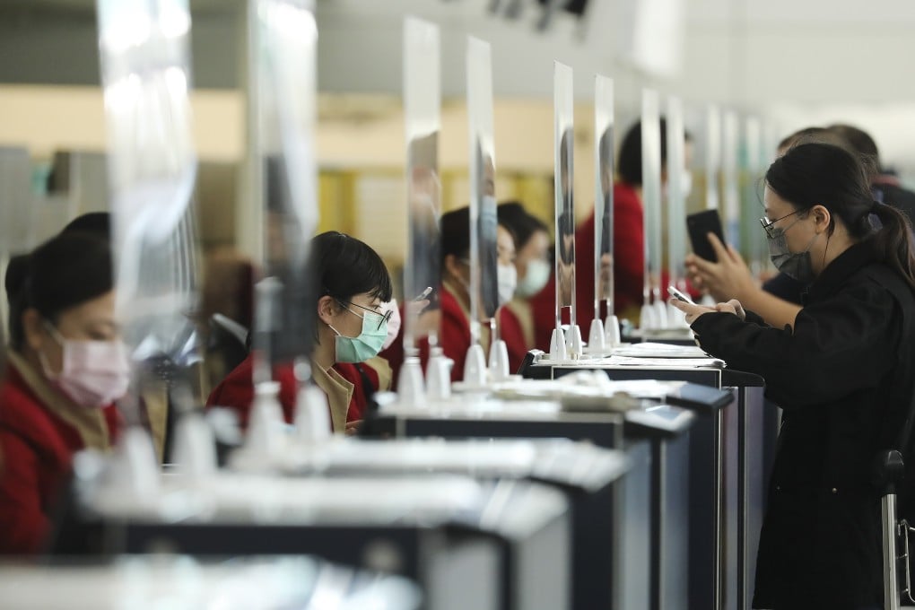 Cathay Pacific staff check-in passengers at Hong Kong International Airport. Photo: K. Y. Cheng