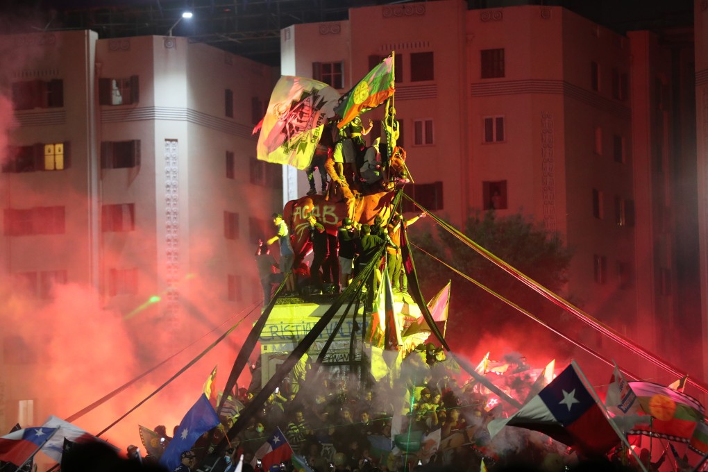 Celebrations erupt in Santiago’s Plaza Italia, the focus of the massive and often violent social protests last year. Photo; Reuters