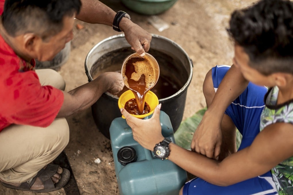 Ayahuasca is poured into a cup in Pucallpa, Peru. A thick brown brew made of the ayahuasca vine and the chacruna bush, its use to treat mental trauma is being investigated by scientists. Photo: Getty Images