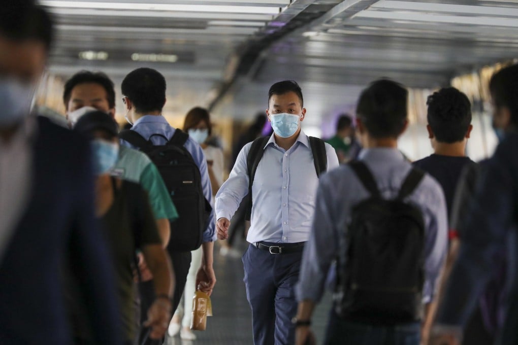People in masks on a crowded footbridge in Central, Hong Kong. Photo: Nora Tam