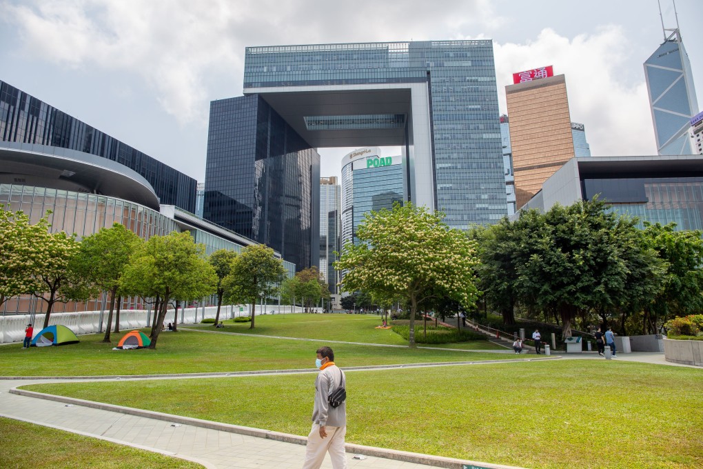 A pedestrian wearing a protective mask walks through Tamar Park in Admiralty. Photo: Bloomberg