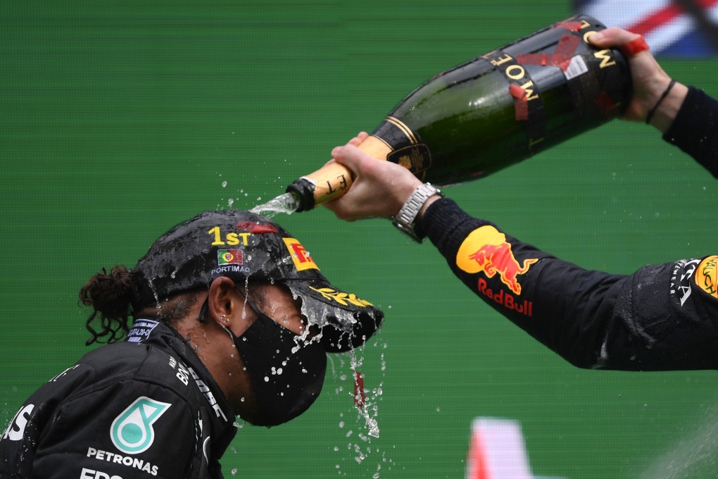 Lewis Hamilton is sprayed with champagne at the podium by fellow Mercedes driver Valtteri Bottas after the Formula One Portuguese Grand Prix at the Algarve International Circuit in Portimao on Sunday. Photo: AP