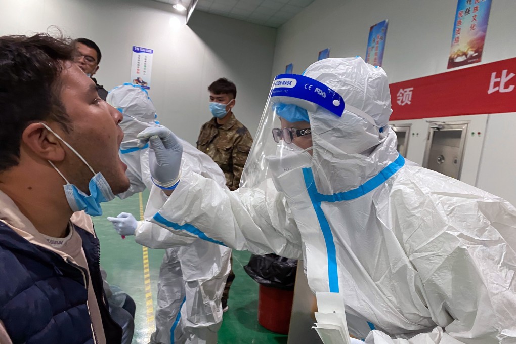 A resident of Kashgar in China’s Xinjiang Uygur autonomous region has a sample taken for nucleic acid testing on Sunday night. Photo: Handout