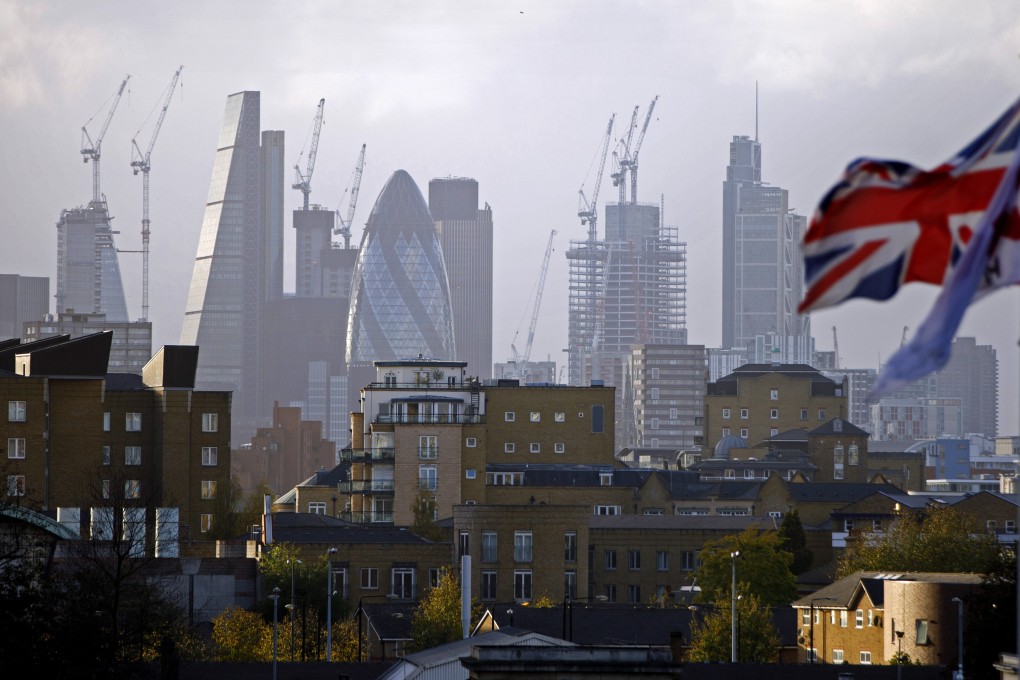 A Union flag flies from a pole as construction cranes stand near skyscrapers in London. Hongkongers have bought more than 7,000 homes in the UK since China imposed a security law in Hong Kong on June 30. Photo: Agence France-Presse
